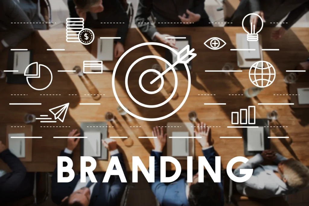 A group of businesspeople sits around a conference table with the word "BRANDING" and marketing icons overlaid—perfectly representing a digital marketing specialist in Kannur focused on teamwork, strategy, and building strong brand presence.